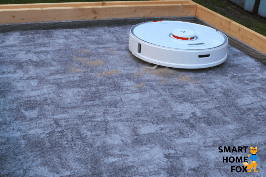 Roborock S7 beim Sand-Saugtest auf einem niedrigen Teppich